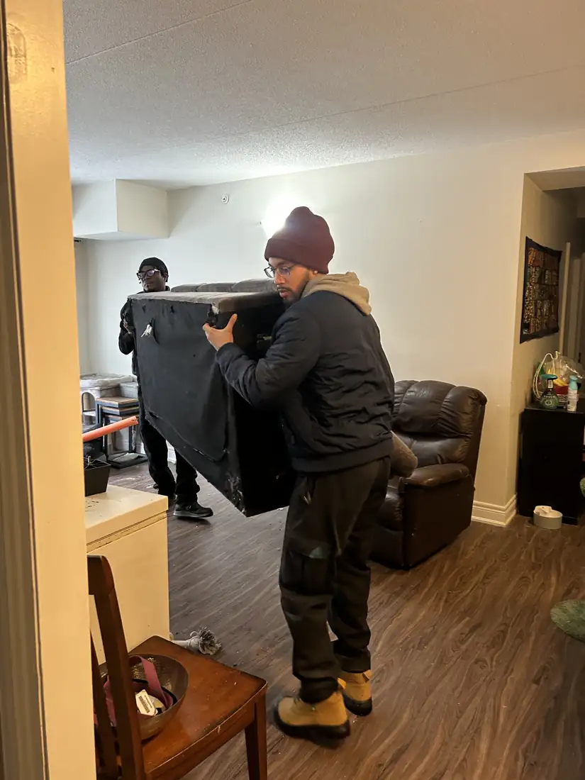 Carrying a couch out of a client's living room