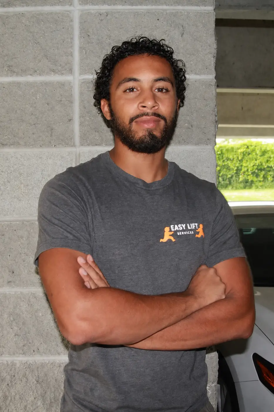 Caydin, owner of Easy Lift Services, in front of his truck