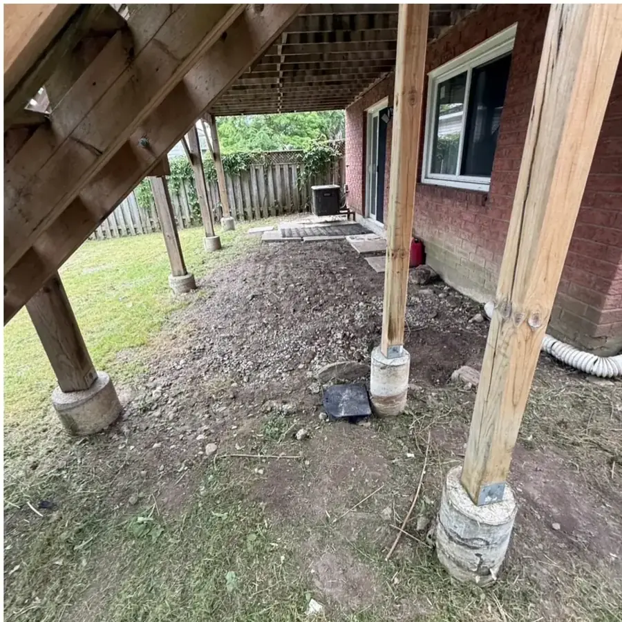 Cleared area under a deck after tires and scrap were hauled away