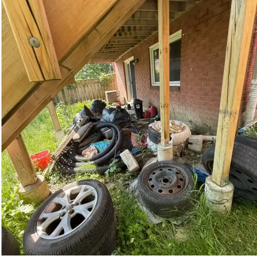 Under-deck area filled with old tires, scrap and debris before removal