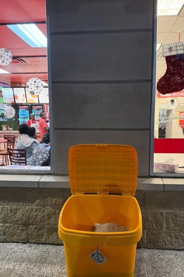 Salt bin filled and placed at a storefront entrance
